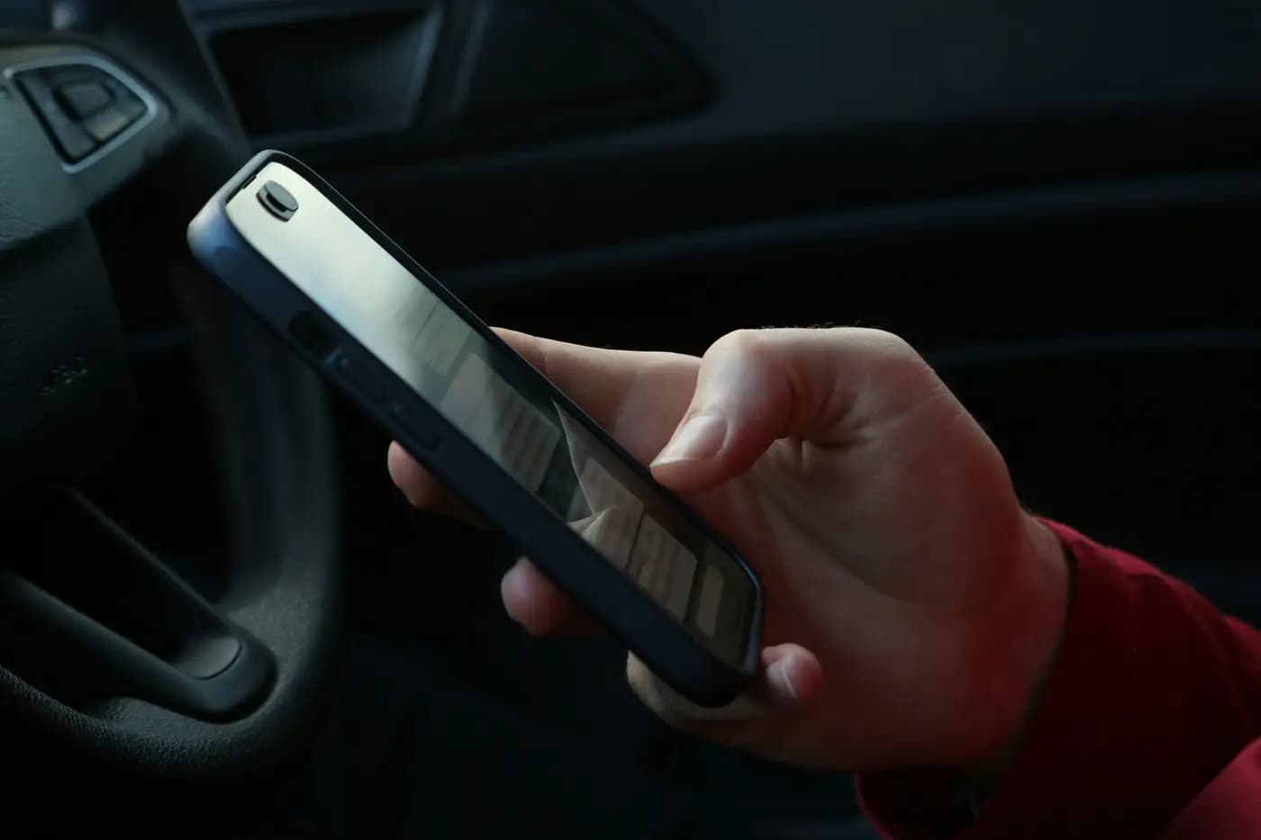 A rep checking a phone in a truck