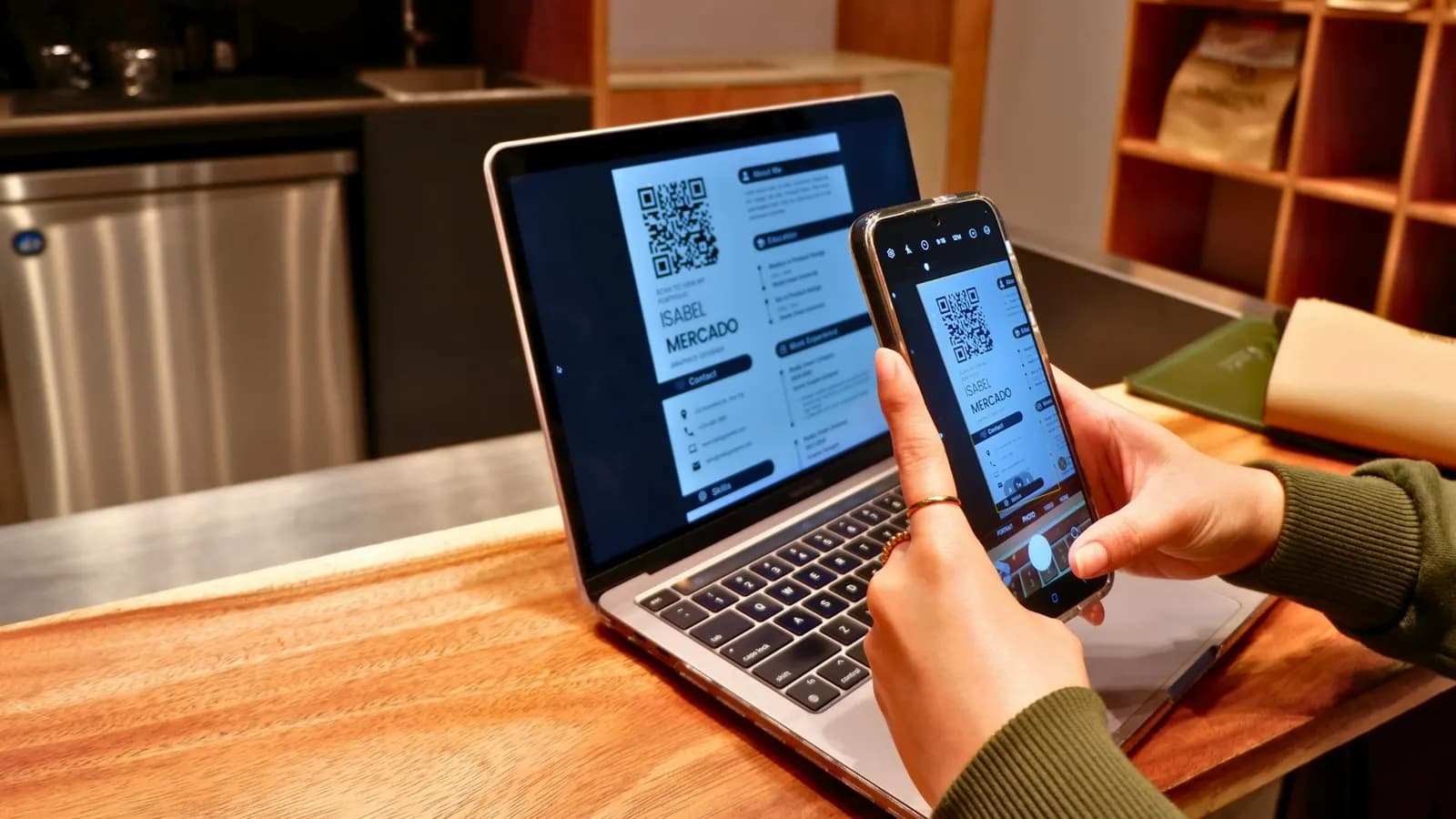Person photographing a document on a laptop screen with a smartphone