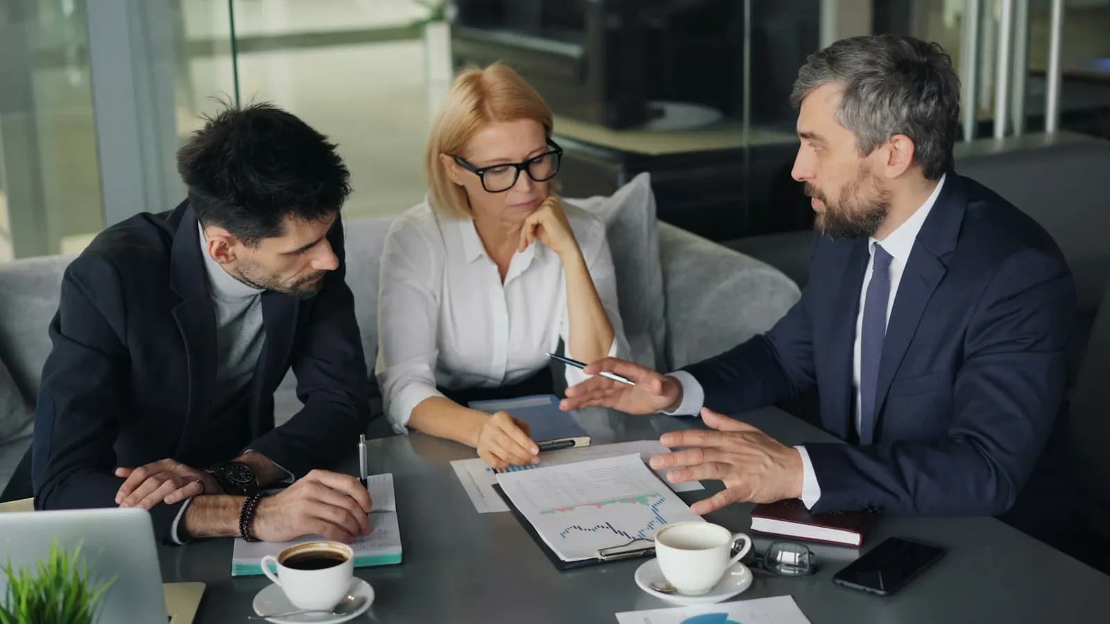 Agent reviewing documents with clients at a table