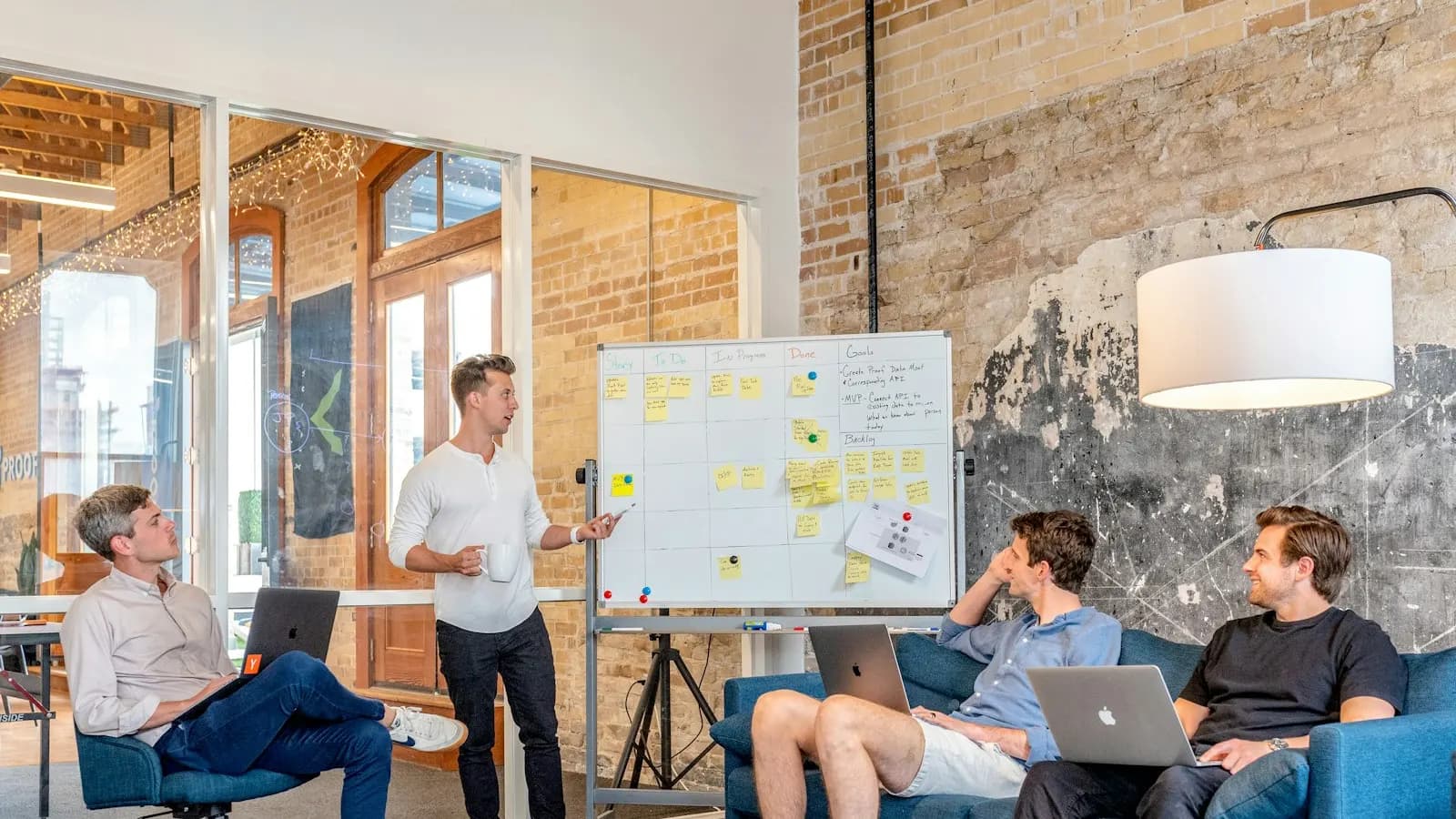 Team planning a campaign at a whiteboard in a bright office