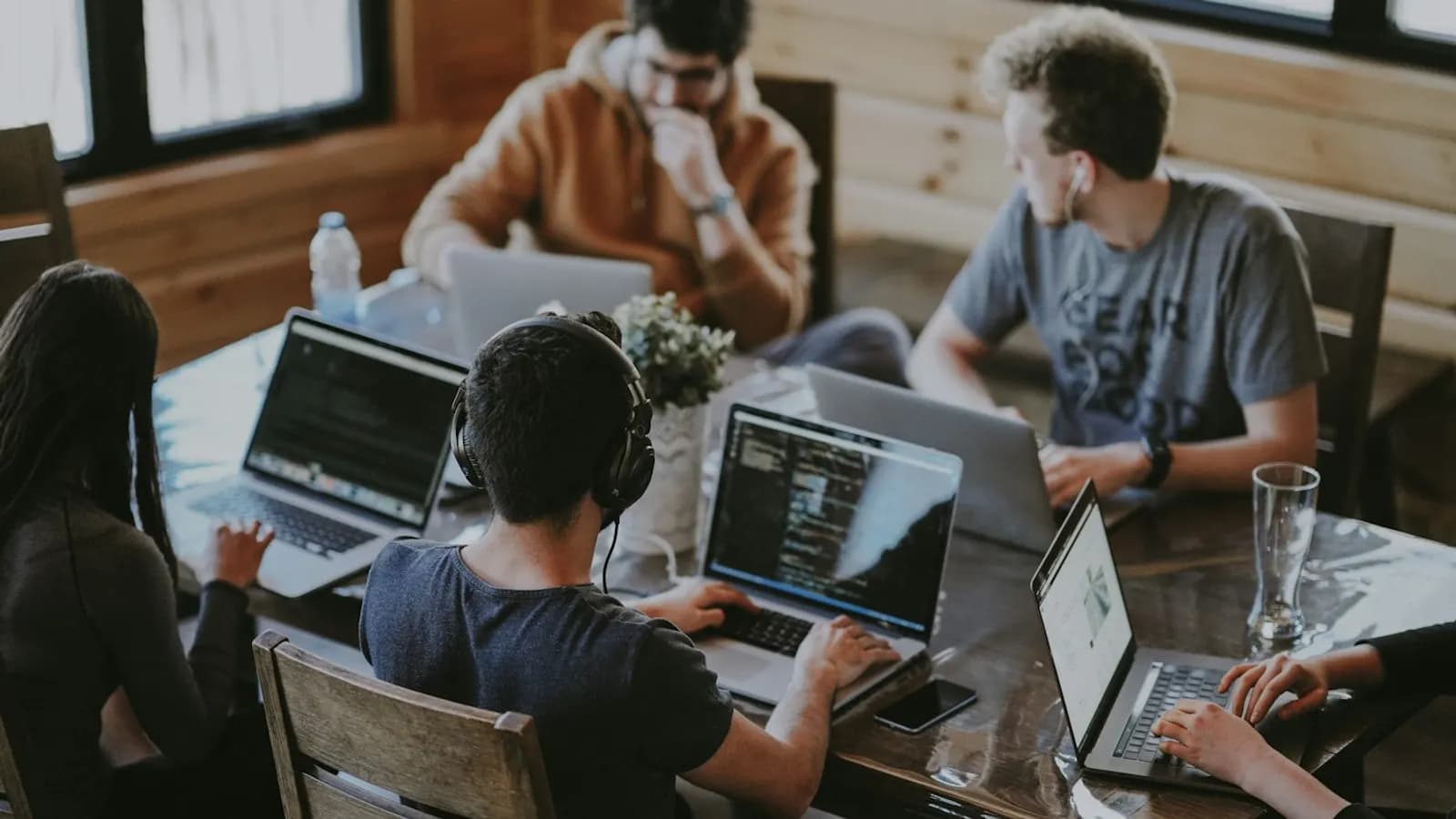 Software team working at laptops around a table