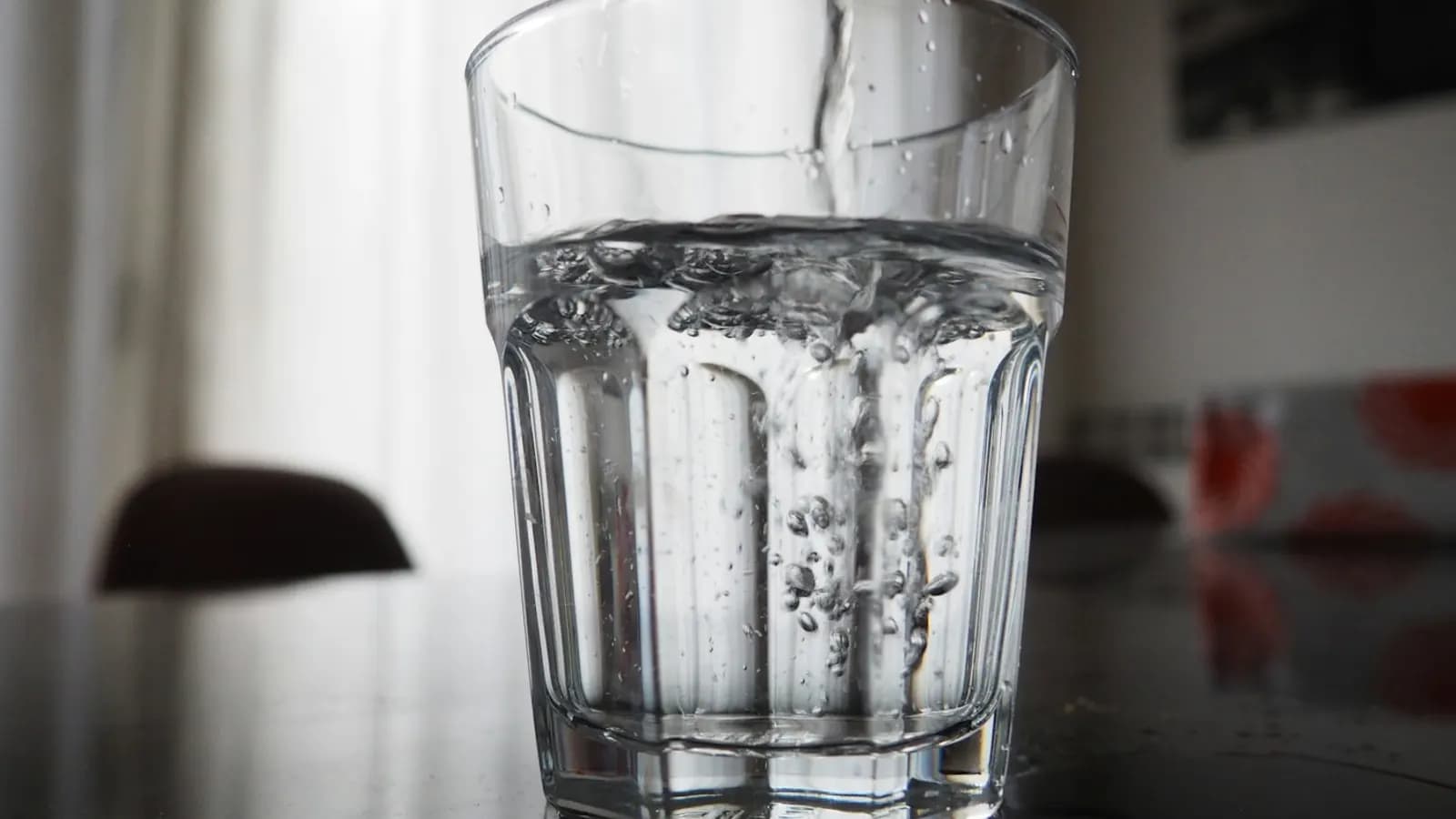 Clean water pouring into a drinking glass